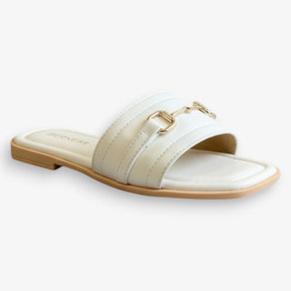 White sandal with gold buckle on a white background