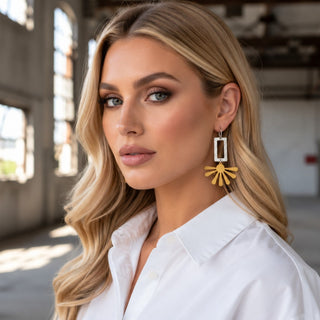 Kitzi Two-Tone Sunburst Earrings on model with silver geometric drop and gold sunburst design