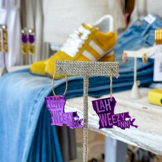 Purple Louisiana hoop earrings with LahWeezyAnna lettering, gold-tone hoops and acrylic state-shaped charms, front product view.