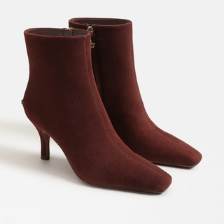 Pair of maroon high-heeled ankle boots on a white background