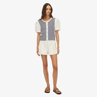 Woman wearing Melissa Nepton Daisy Top in navy and white stripes with puff sleeves and front buttons