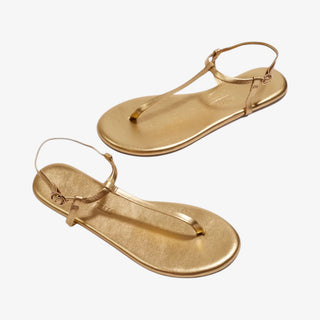 TKEES gold thong sandal pair minimal strappy flat sandals angled view