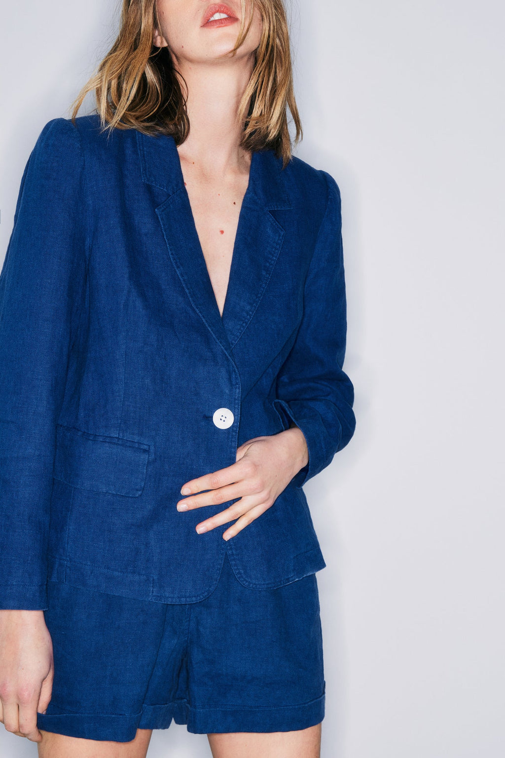 Detailed view highlighting button closure, long sleeves, and a notched collar of the Melissa Nepton Glen Blazer in elegant Batik Blue.