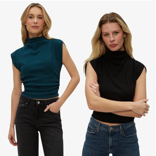 Two women wearing Michael Stars Amara sleeveless mock neck tops and jeans on a white background