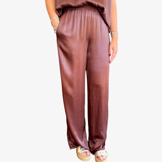 Brown pants worn by a person on a white background