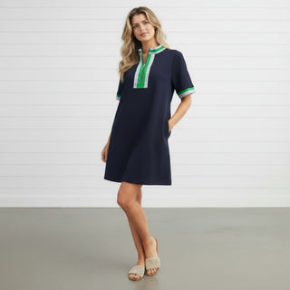 Navy shift dress with green and white trim neckline front view styled with neutral slide sandals in studio setting