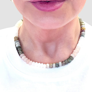 Neutral gemstone beaded necklace close-up styling view with mixed pastel and natural stone beads on white top