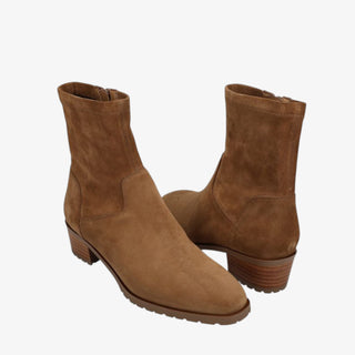 Pair of brown suede ankle boots on a white background