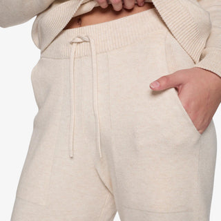 Cream sweater-knit lounge pant with relaxed straight-leg fit and elastic drawstring waistband.