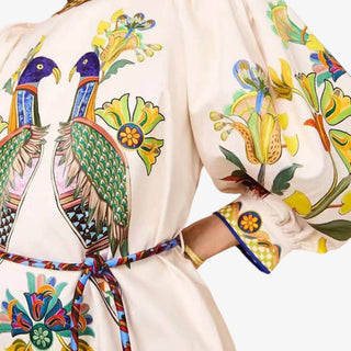 Peacock maxi dress with colorful bird print puff sleeves and waist tie front view
