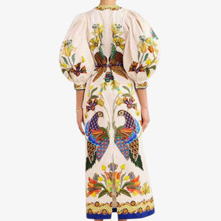 Colorful dress with peacock and floral statement design on a white background