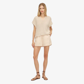 Model wearing the Melissa Nepton Harlan Sweater in a neutral lightweight knit with relaxed short sleeves and a v-neck.