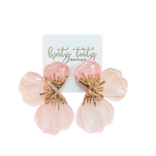 Pink flower-shaped earrings with gold accents on a white card from hoity totty boutique.