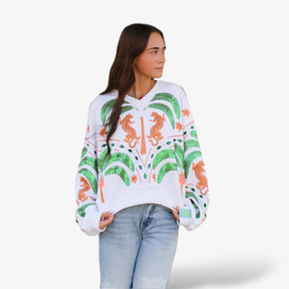 Woman wearing a white sweater with colorful patterns on a white background