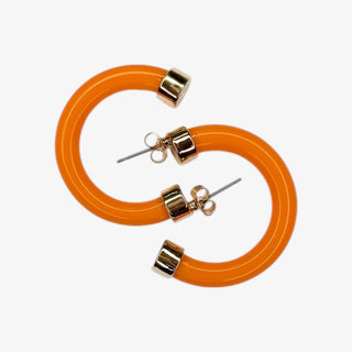 Orange hoop earrings with gold accents on a white background