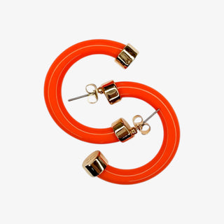 Orange hoop earrings with gold accents on a white background