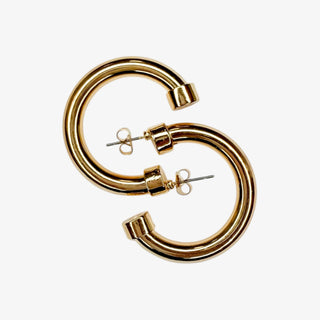 Gold hoop earrings on a white background