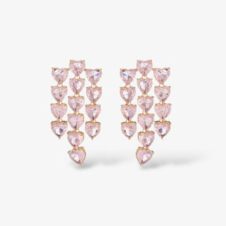 A pair of gold-colored earrings featuring pink heart-shaped crystals arranged in a cascading design.