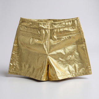 Gold metallic shorts on a light gray background
