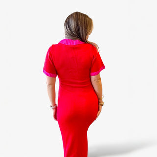 Red knit midi dress with pink trim on collar, sleeves, and pockets styled on a woman against a clean white background.