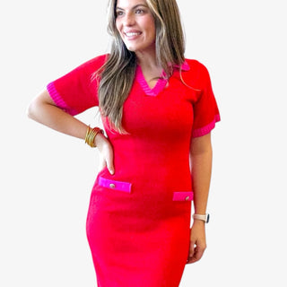 Red knit midi dress with pink trim on collar, sleeves, and pockets styled on a woman against a clean white background.
