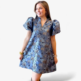 Woman wearing a blue floral dress on a white background