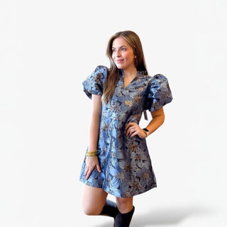 Woman wearing a blue floral dress on a white background