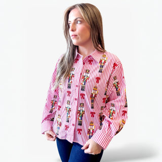 Woman wearing a red and white striped shirt with decorative patterns on a white background