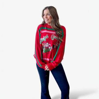 Woman wearing a red Christmas sweater with festive design on a white background