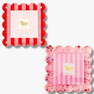 Two decorative frames one with a pink and red striped design and one with a pink glitter design on a white background.