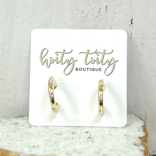 Classic gold hoop earrings with polished finish displayed on jewelry card
