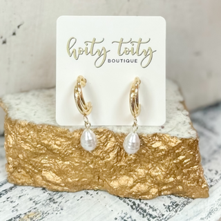 Classic gold hoop earrings with polished finish displayed on jewelry card 
