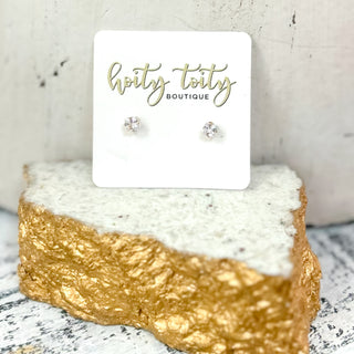 CZ fashion stud earrings with cubic zirconia stones in assorted sizes and shapes on display card