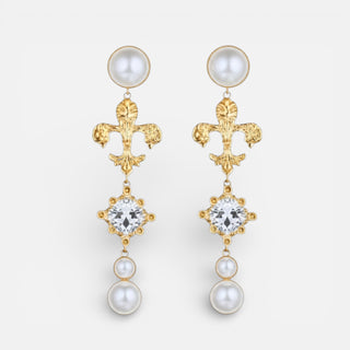 Gold fleur de lis drop earrings with crystal center stone and cascading pearl accents.