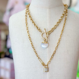 Opal gemstone gold filled pendant necklace with toggle clasp layered with chain necklaces on mannequin