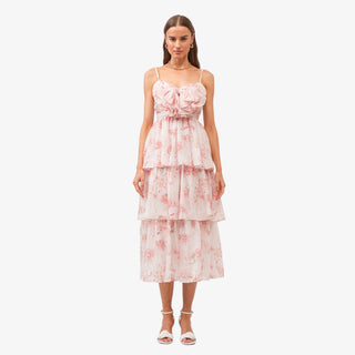 Pink floral tiered midi dress with bow detail bodice and ruffle layers styled with white heels