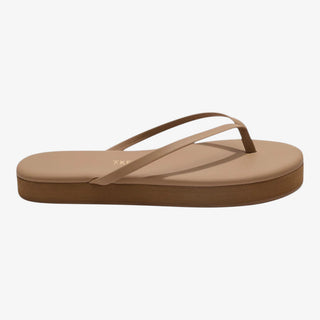 tan leather flip flop sandal on foot casual outfit styling side view