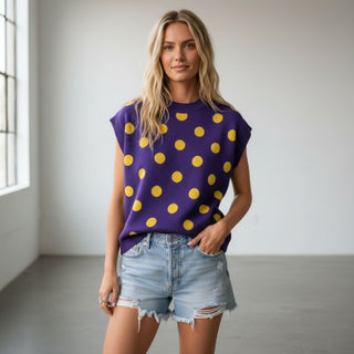 Purple and gold polka dot sleeveless knit top styled with distressed denim shorts, front view for a game day outfit.