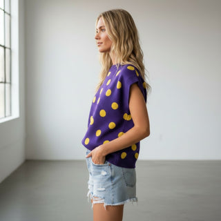 Polka dot sleeveless knit top in purple and gold with denim shorts, everyday game day outfit, side view