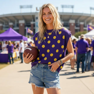 Model wearing purple sweater with yellow polka dots. Sleeveless sweater for a LSU gameday 