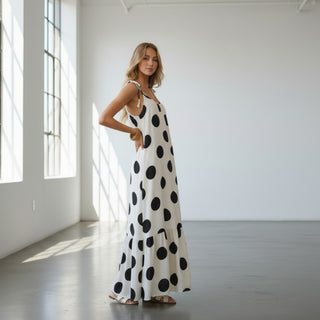 Black and white polka dot maxi dress with oversized dot print and tiered hem side view