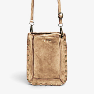 A light taupe suede crossbody bag with a rectangular silhouette, decorated with brass-tone metal studs along the borders and a matching adjustable shoulder strap.