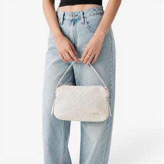 Cream woven hobo shoulder bag with textured vegan leather design, adjustable shoulder strap, and gold hardware front view