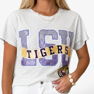 Close-up of Queen of Sparkles LSU Metallic Banner Tee showing purple sequin LSU letters, gold Tigers banner and tiger mascot detail