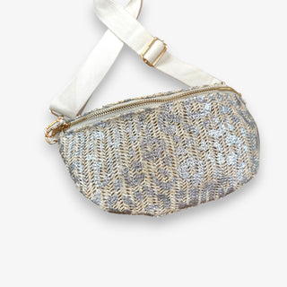 Cream raffia leopard crossbody bag with metallic silver animal print, gold zipper , adjustable cream strap, and gold hardware front view.