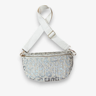Cream raffia leopard crossbody bag with metallic silver animal print, gold zipper closures, adjustable cream strap, and gold hardware front view.