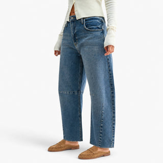 angle.jpg	Raw hem barrel jeans with a relaxed silhouette and seam detailing, paired with an ivory cardigan and tan loafers, angled view.