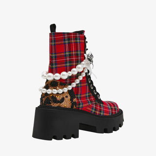 Betsey Johnson red plaid combat bootie with pearls, bows, and chunky black lug sole for bold holiday dressing