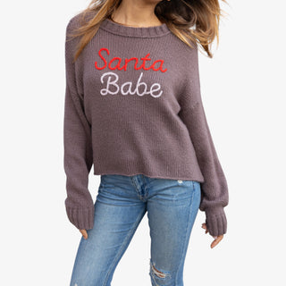 Person wearing a sweater with 'Santa Babe' text on a white background