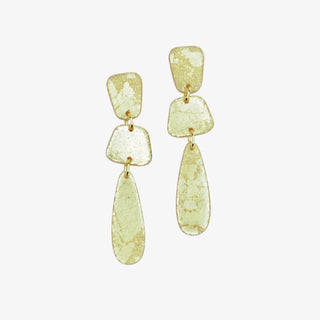 Pair of gold earrings with gold foil-like designs on a white background